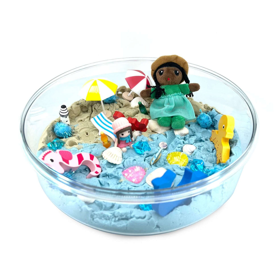 Beach Day Kinetic Sand Kit with Organic Cotton Beach Figure with Dark Skin, Umbrellas, Beach Chairs, Bottles, Seashells, Wooden Sea creatures and more from Blossom & Bloom Kids - Beach Day, Ocean Theme Set with Kinetic Sand - Blossom & Bloom Kids