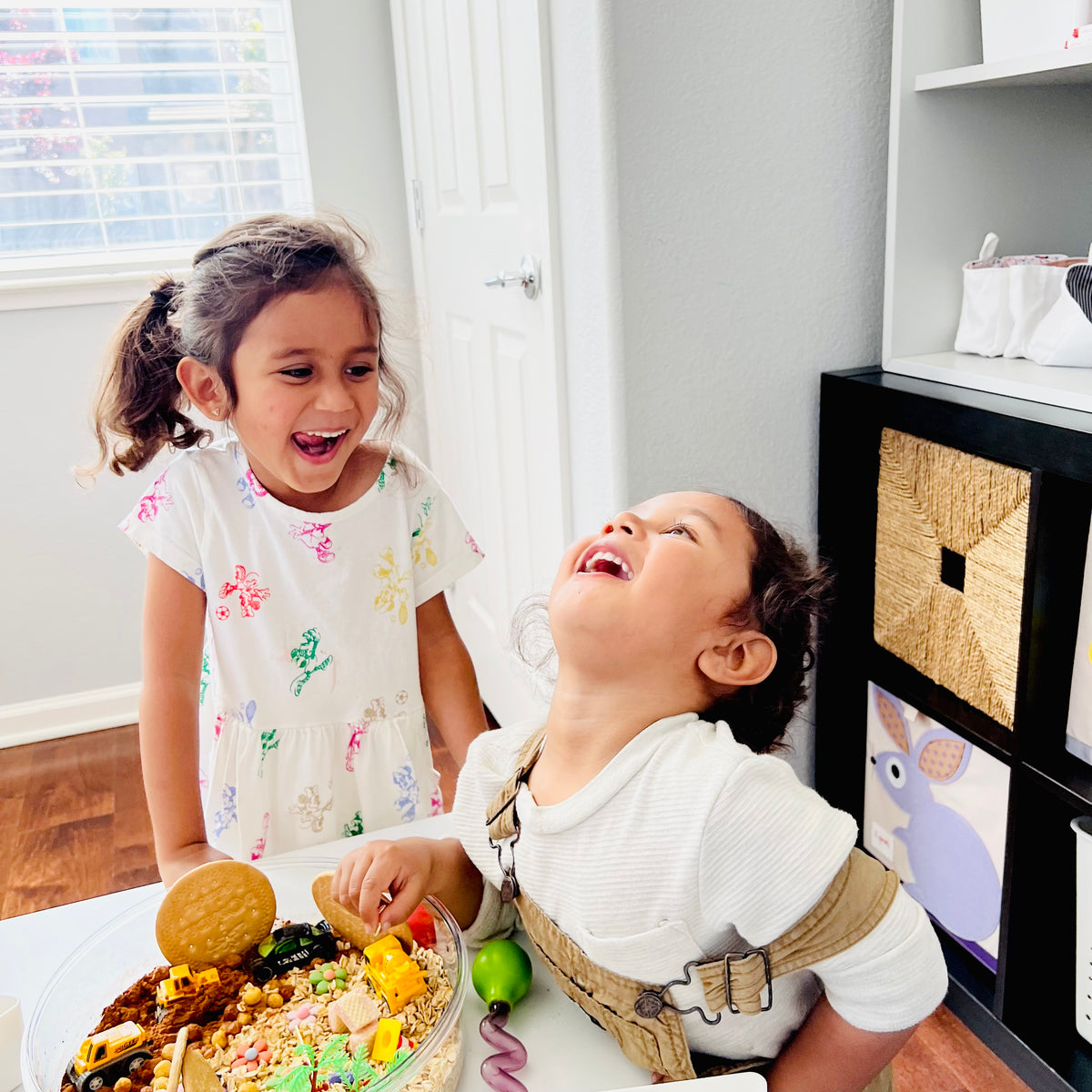 Kids laughing while playing with a Blossom & Bloom sensory play kit