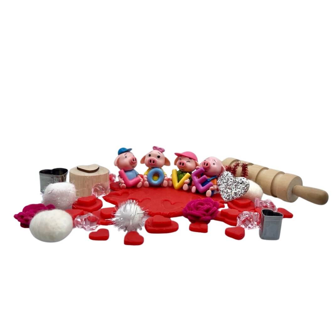 Front view of Toy pigs with letters LOVE and red playdough with heart stamped included in All You Need Is Love Bloom Bag from Blossoms & Bloom Kids - All You Need Is L-O-V-E, Playdough Kit - Blossom & Bloom Kids